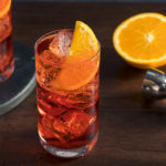 Un cocktail Americano rafraîchissant avec un garnish orange